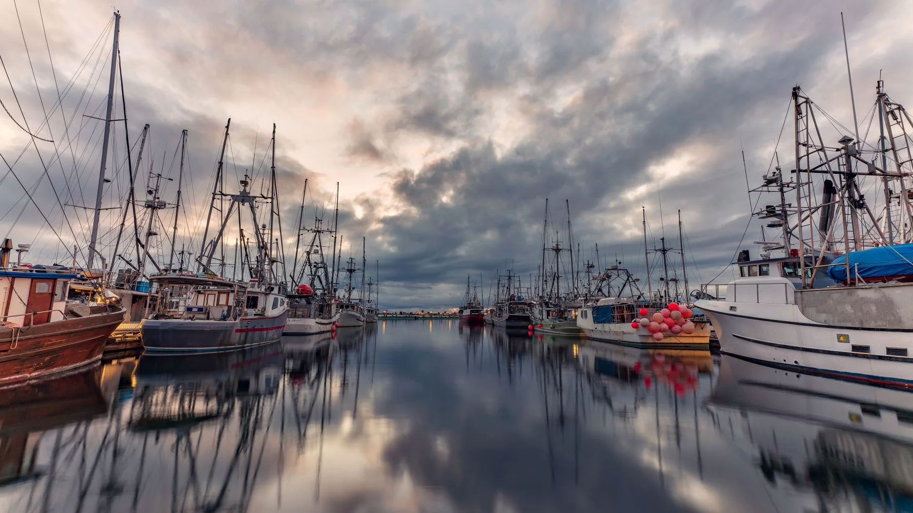 Boats reflected in a quiet marina