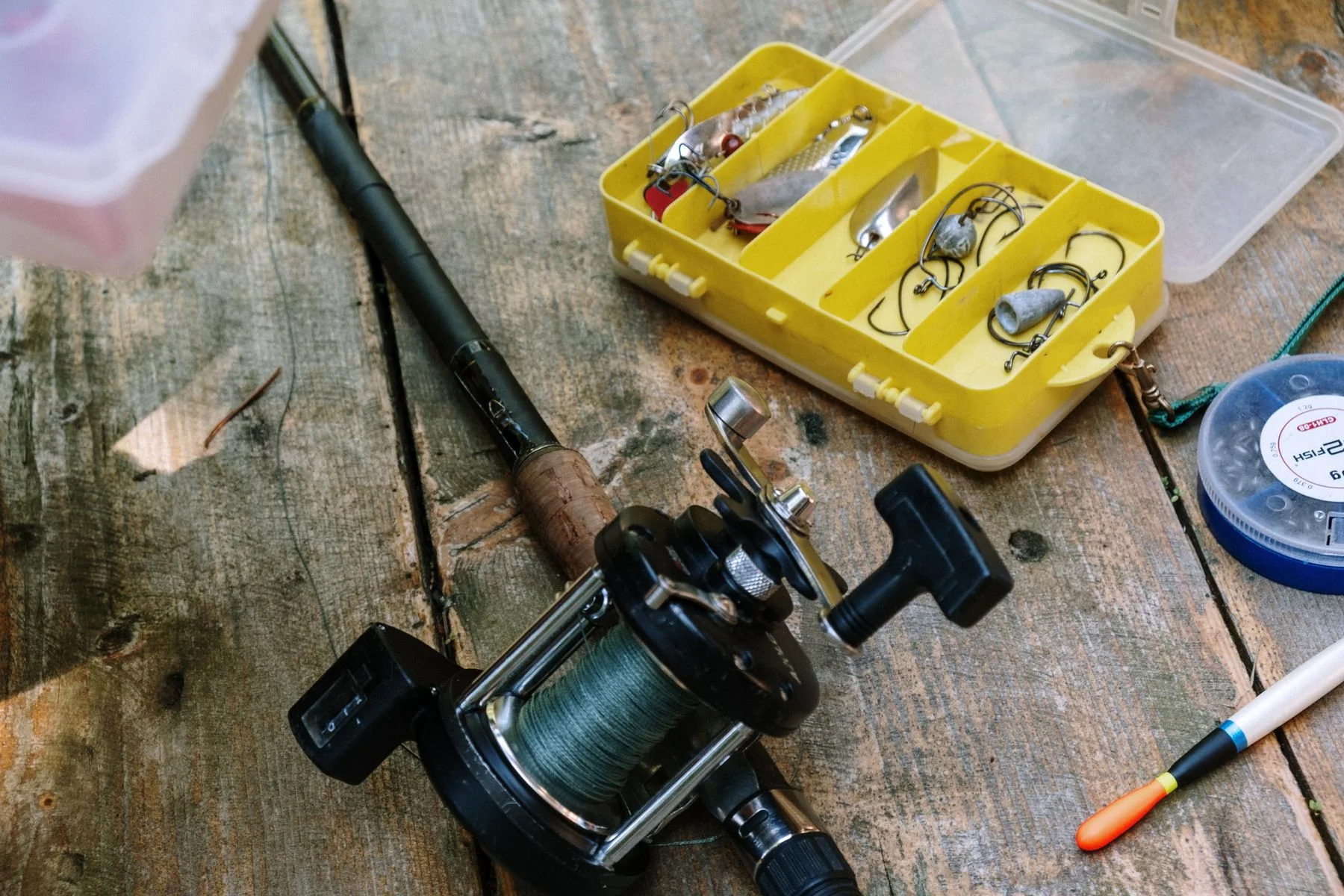 Rod reel and tackle on a wooden table